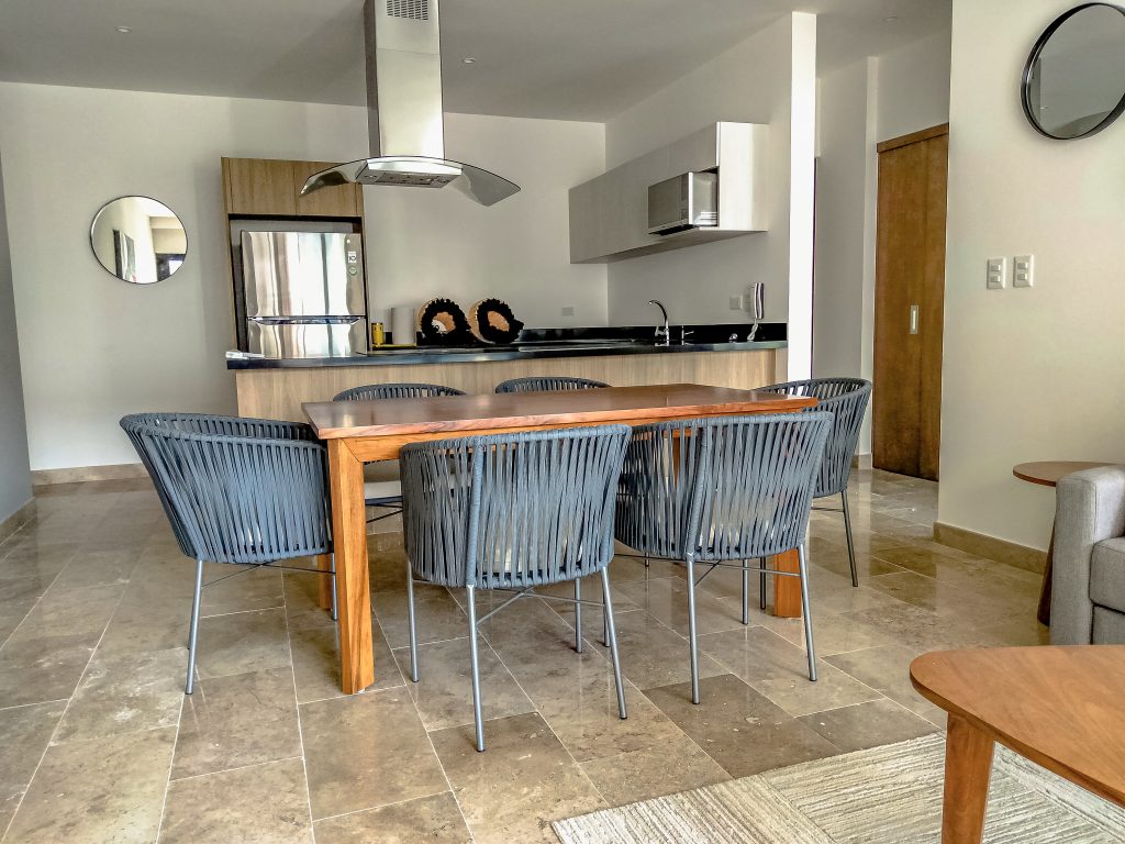 Dining room furnished by Homiture — rental-ready unit in the Riviera Maya