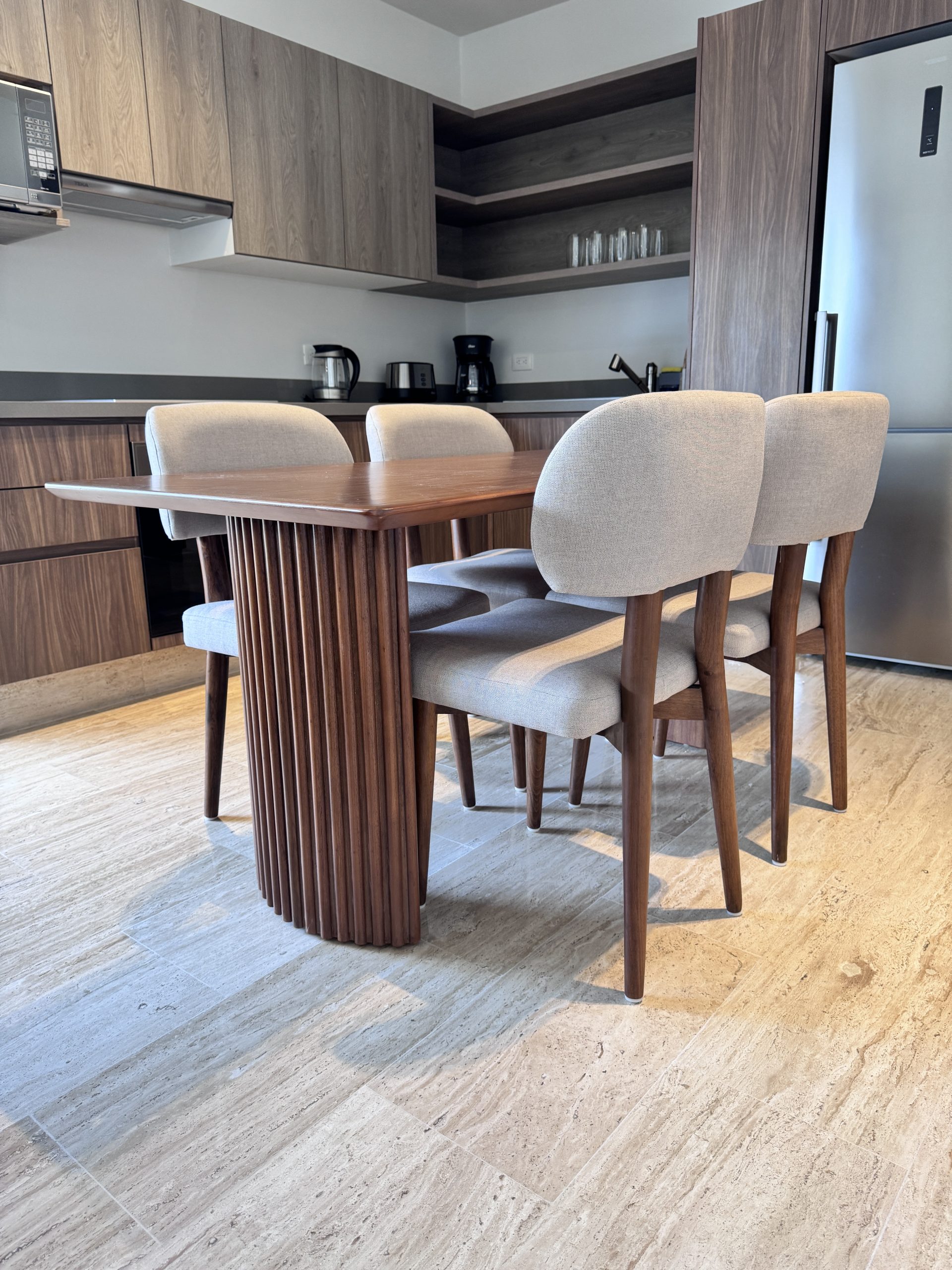Dining room furnished by Homiture — rental-ready unit in the Riviera Maya