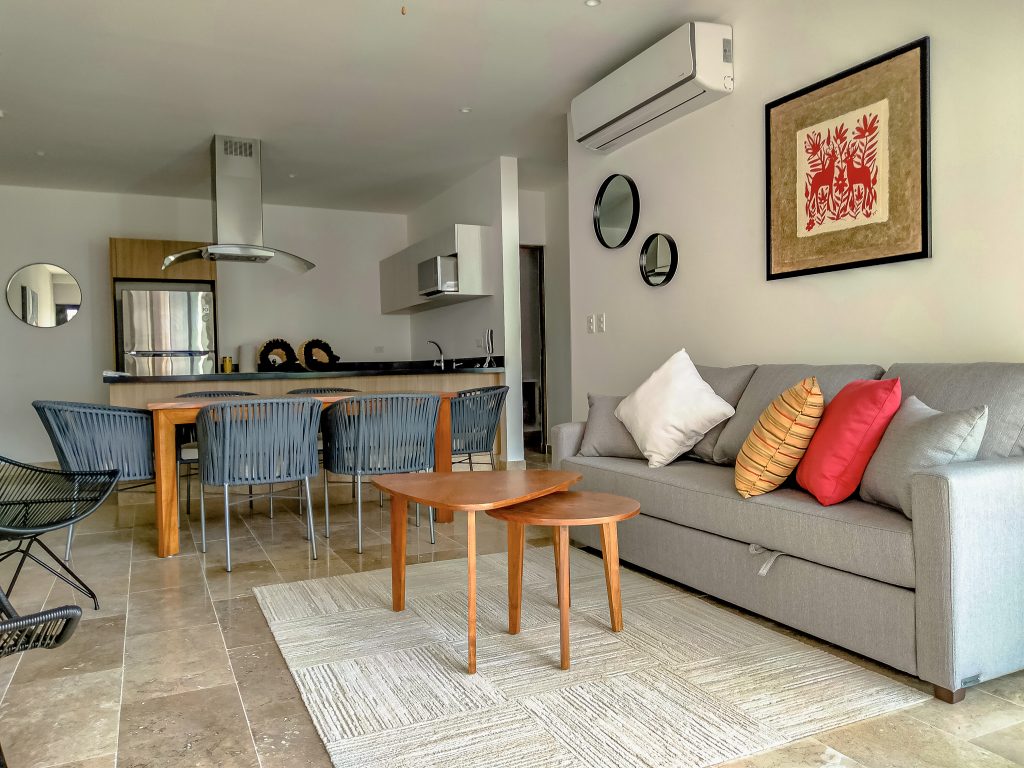 Living room furnished by Homiture — rental-ready unit in the Riviera Maya
