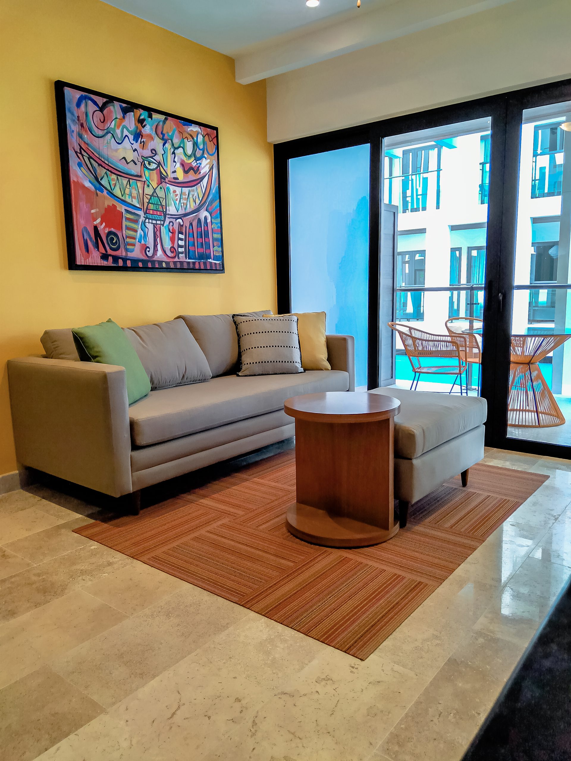 Living room furnished by Homiture — rental-ready unit in the Riviera Maya