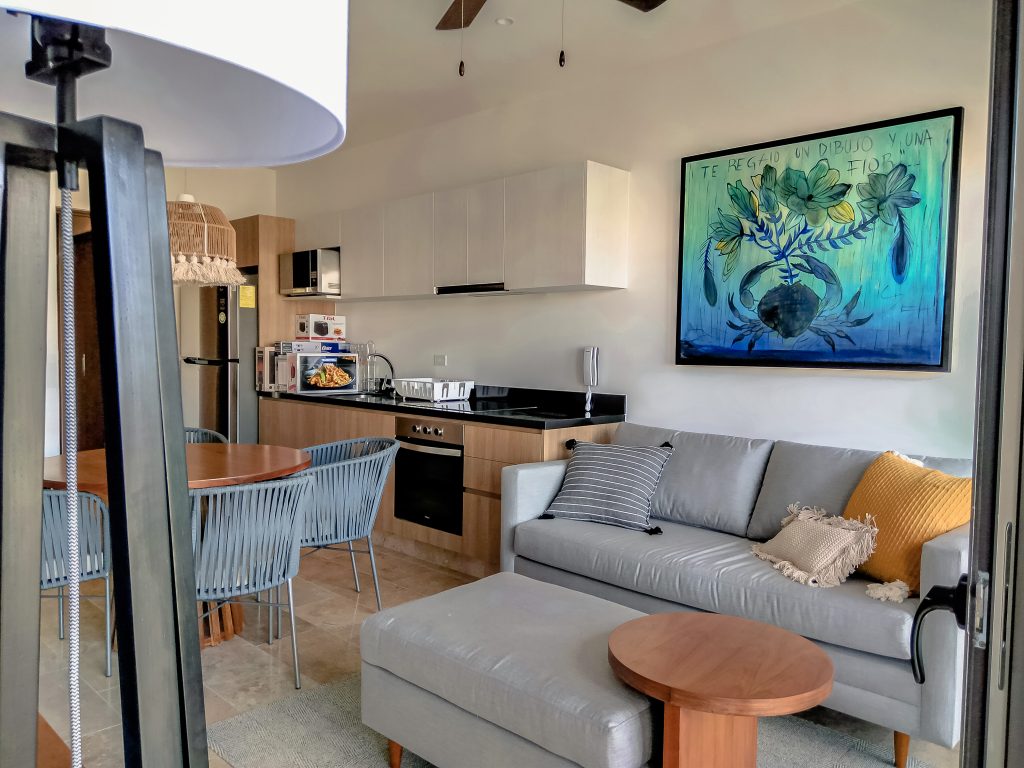 Living room furnished by Homiture — rental-ready unit in the Riviera Maya