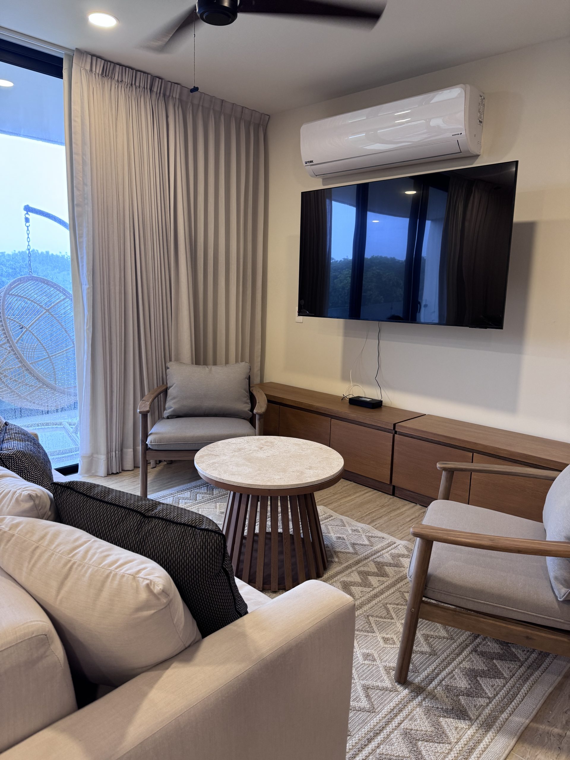 Living room furnished by Homiture — rental-ready unit in the Riviera Maya