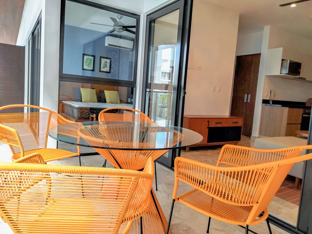 Terrace furnished by Homiture — rental-ready unit in the Riviera Maya